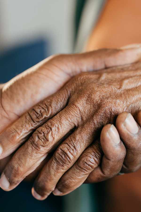 Two hands clasped together showing connection and care