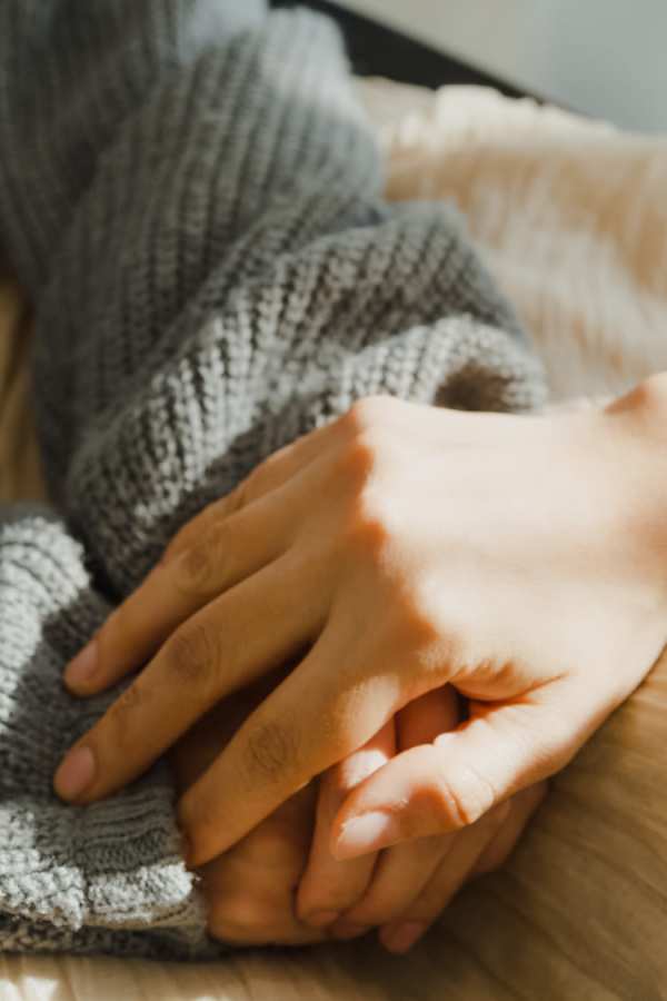 Close-up of two hands clasped together