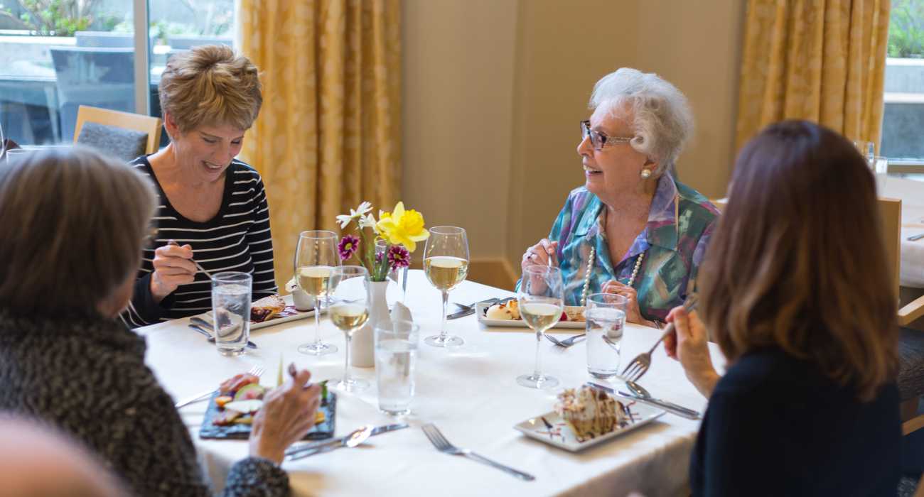 Residents enjoying a meal together in the dining room