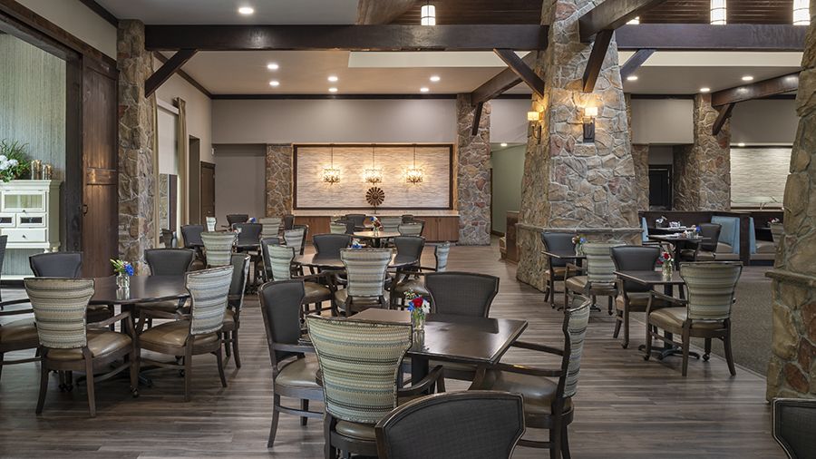 Dining room set up for residents with tables and chairs