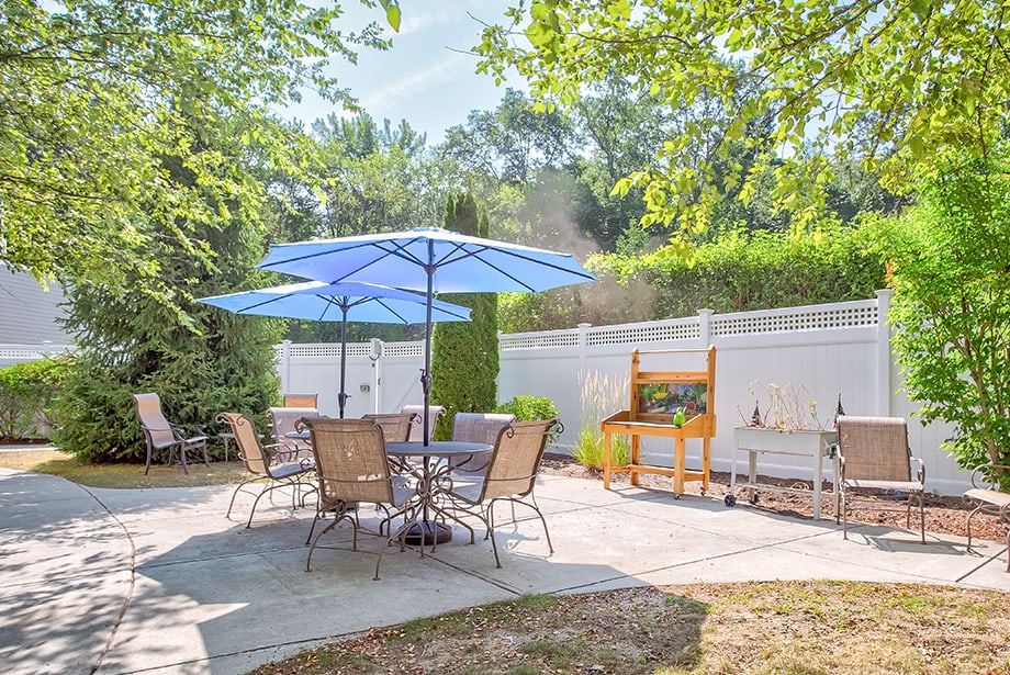 Outdoor seating area with umbrellas and a garden
