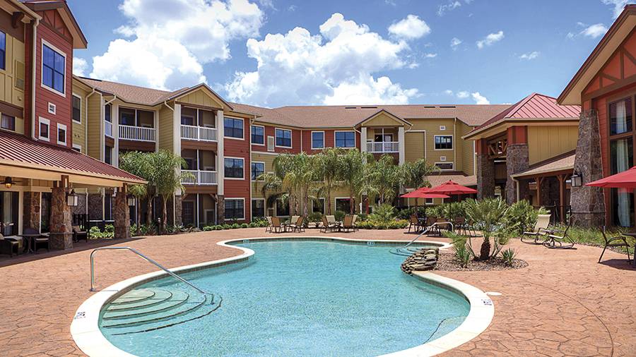 Outdoor pool area surrounded by residential buildings