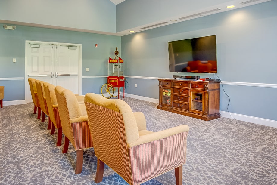Interior of a common area with chairs and a TV