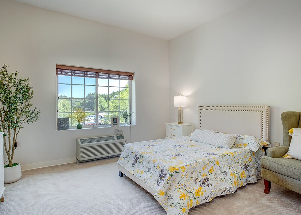 A well-furnished resident room with natural light