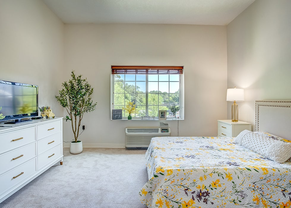Bright and inviting resident room with floral bedding