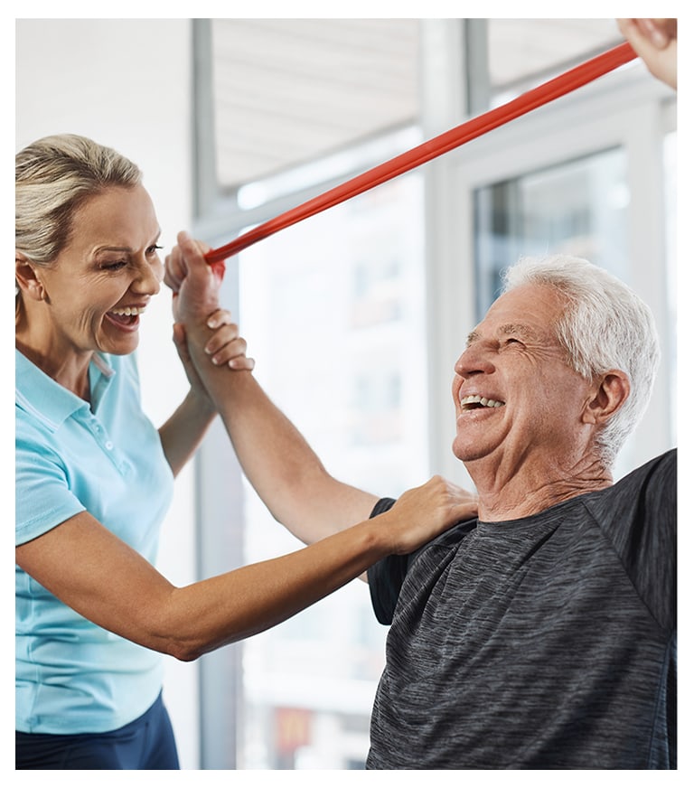 Staff assisting a resident with exercises