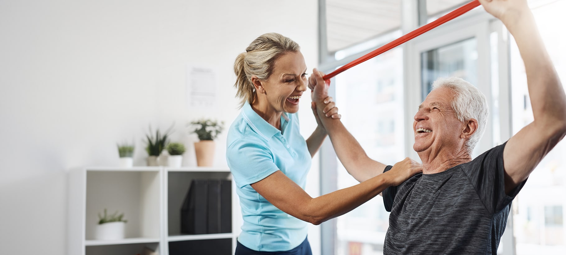 Therapist assisting an elderly man with exercise