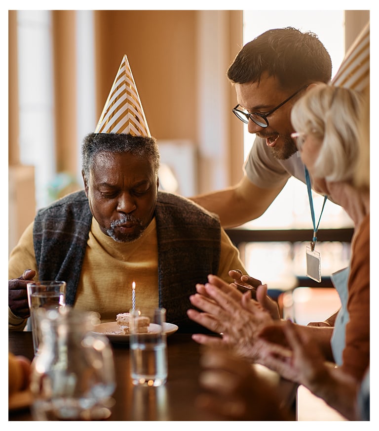 Residents celebrating a birthday with cake