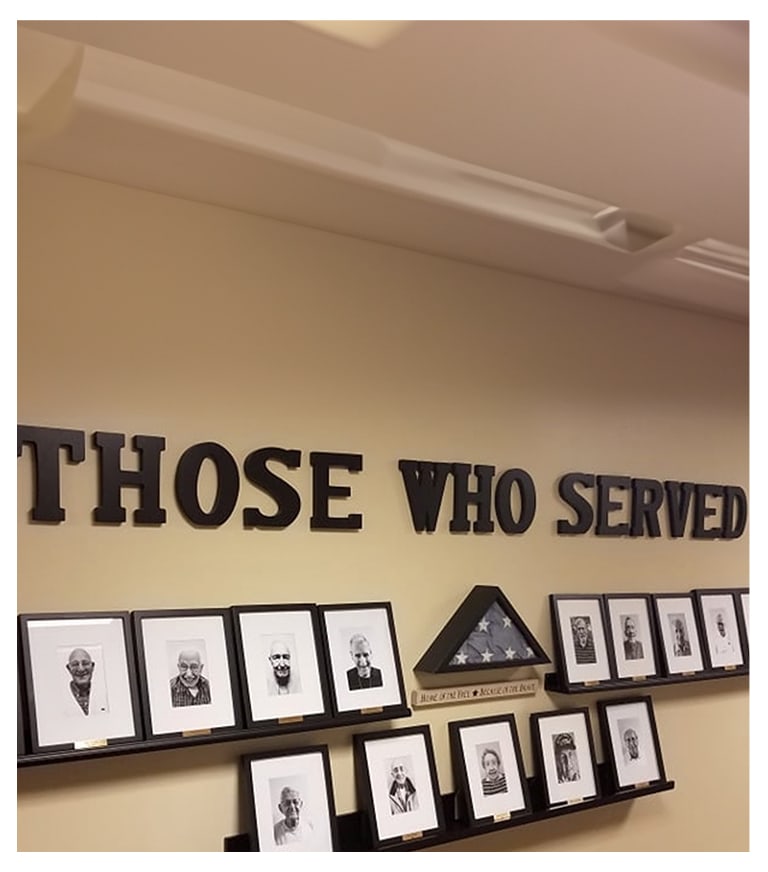 Wall display honoring veterans with portraits