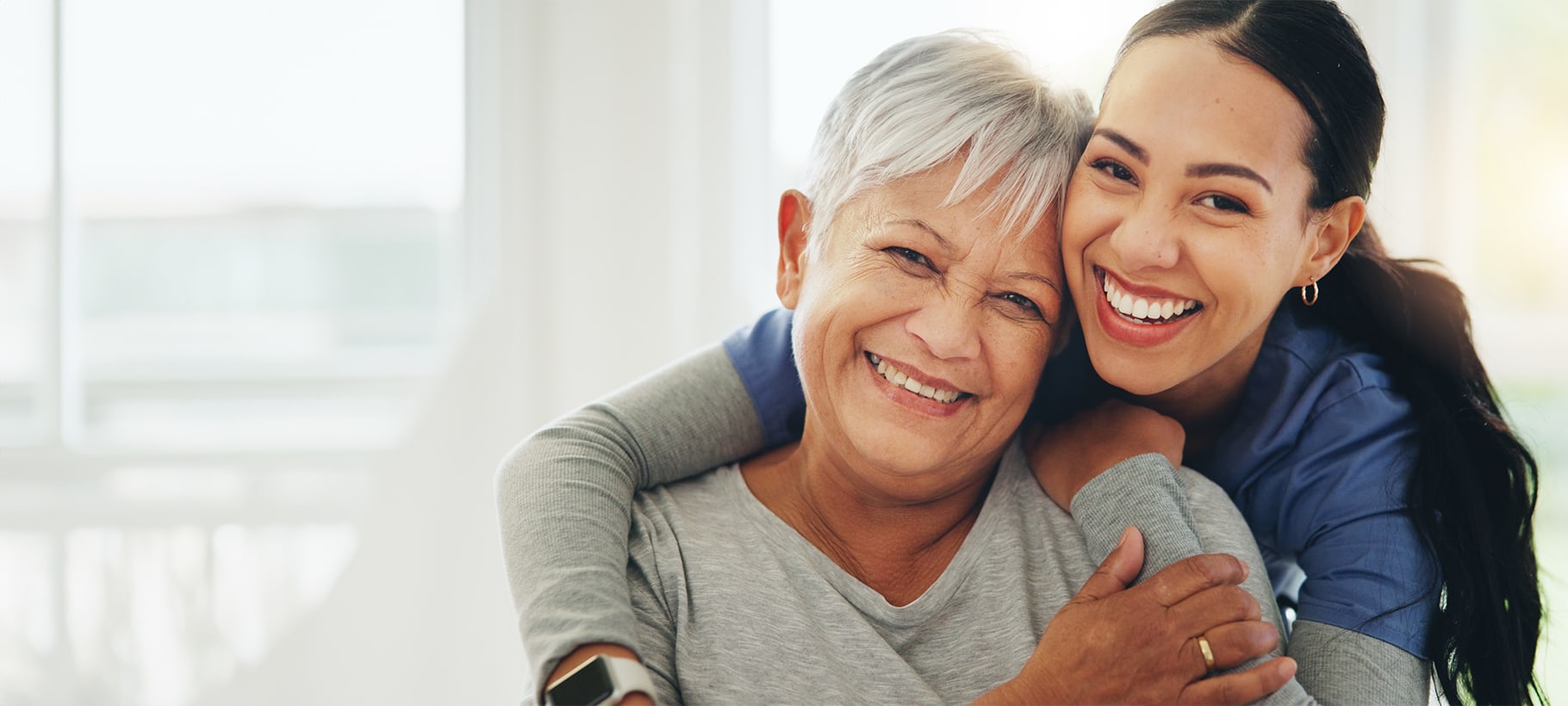 Caregiver and resident sharing a joyful moment
