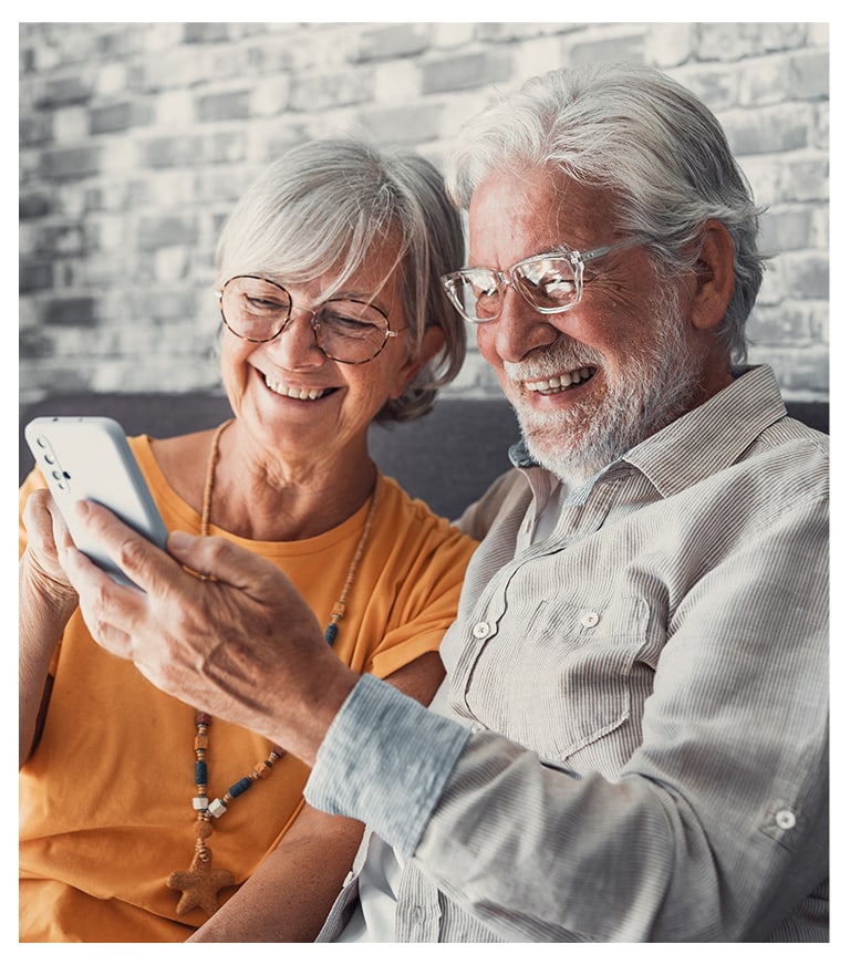 Seniors enjoying time together looking at a phone