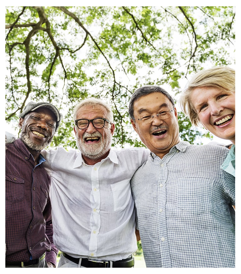 Four residents smiling together outdoors
