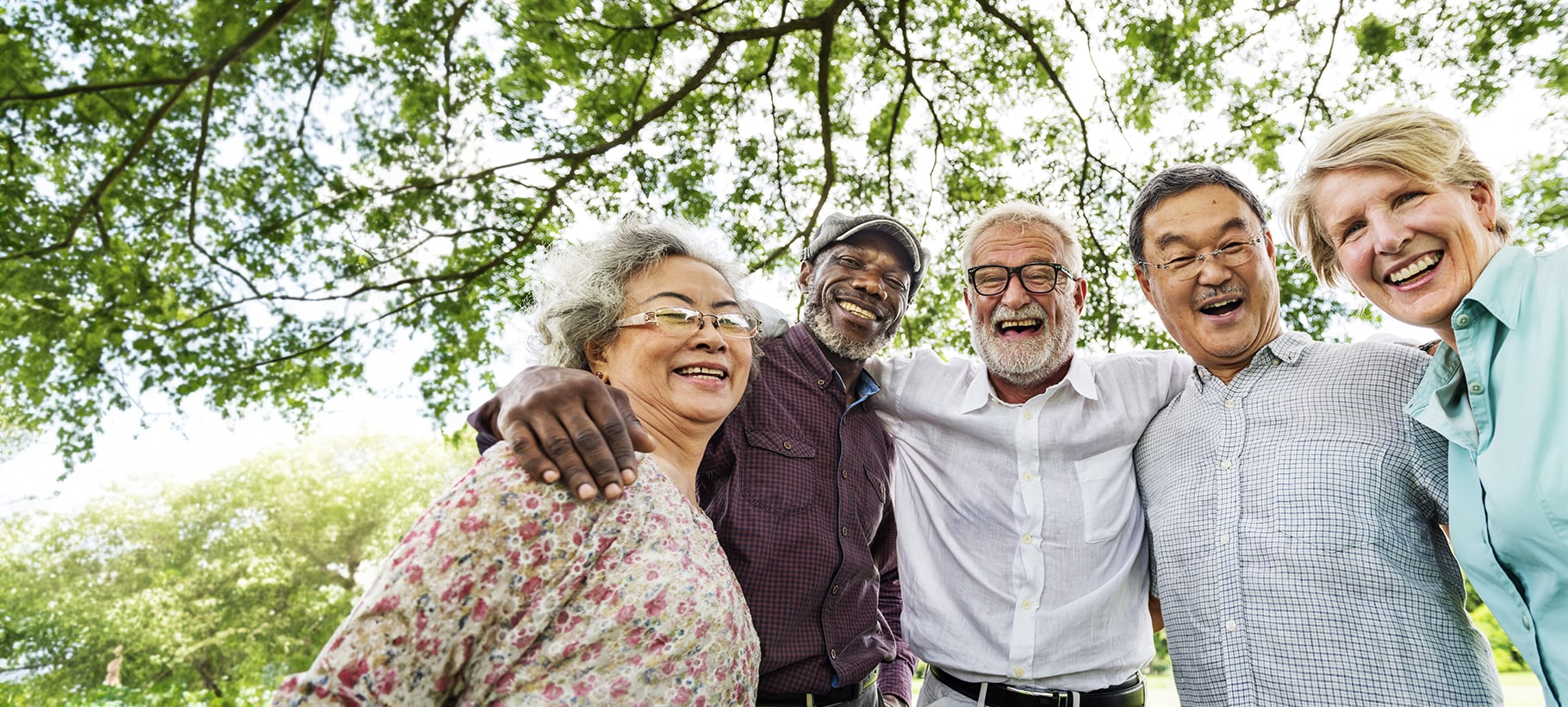 Residents enjoying a joyful moment outdoors under a tree