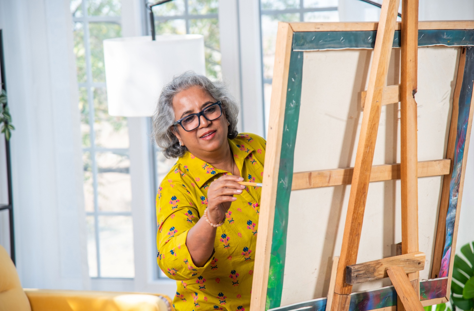 Resident participating in an art activity in a common area