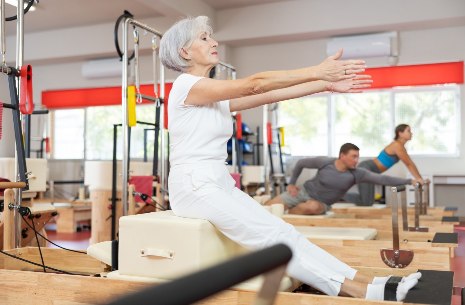 Residents participating in a Pilates class in a fitness area