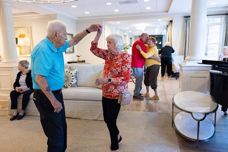 Residents dancing and enjoying an indoor activity