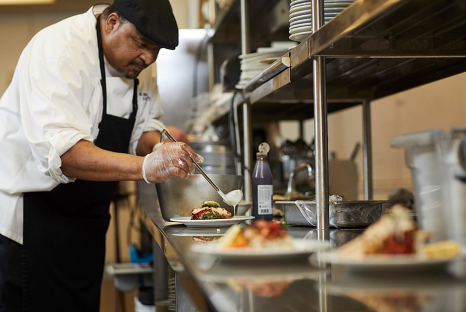 Chef plating a dish in the kitchen