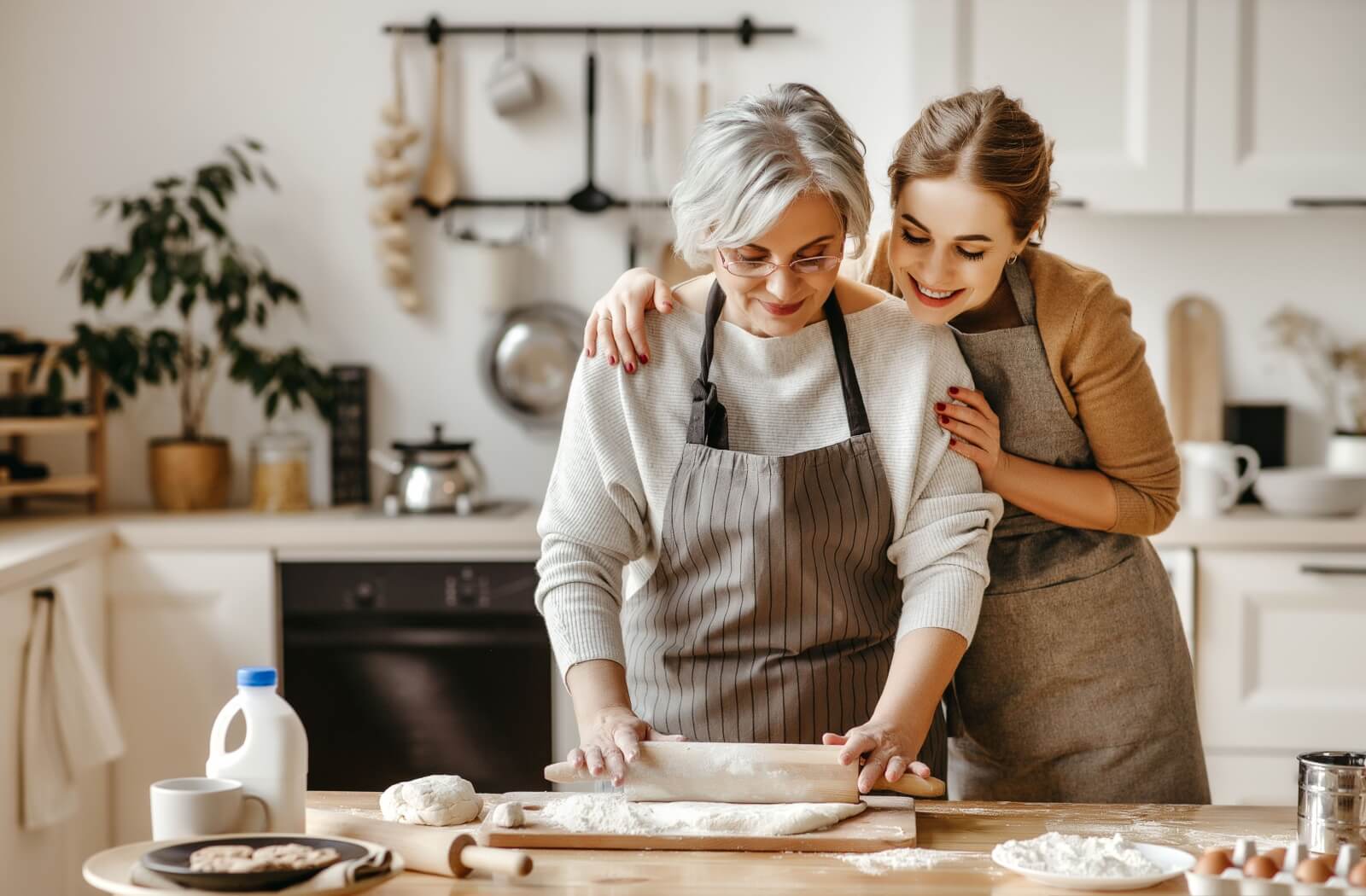 Two women baking together in a cozy kitchen