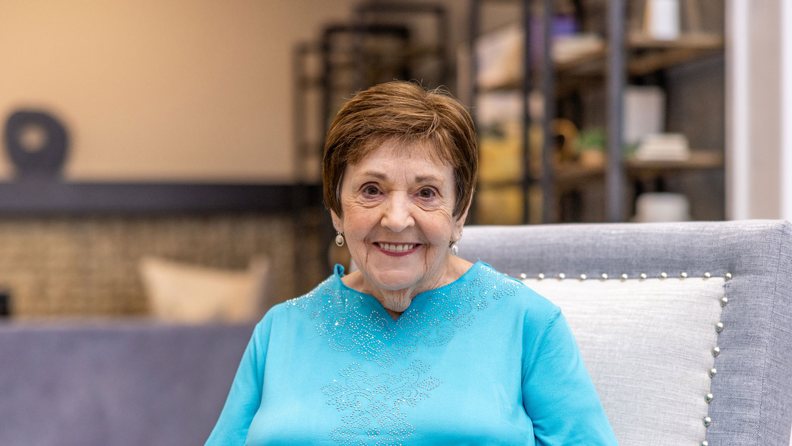 Resident smiling in a comfortable interior space
