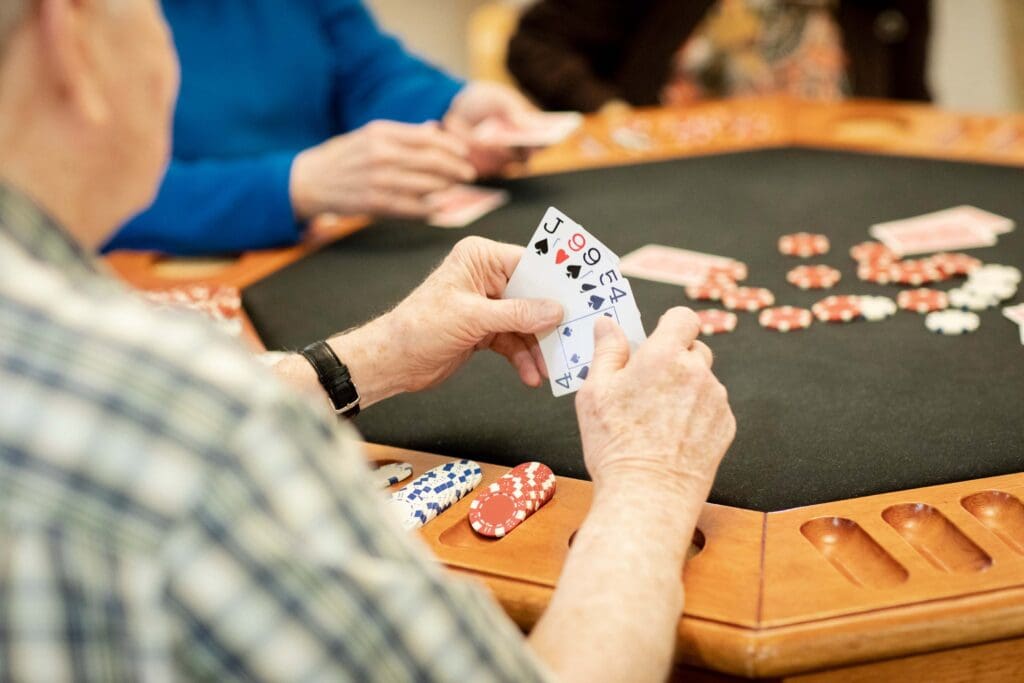 Residents playing poker in a social setting