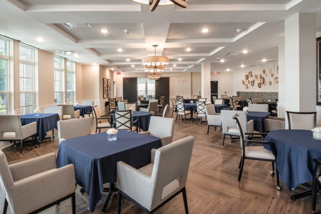 Bright dining room with tables and chairs set up