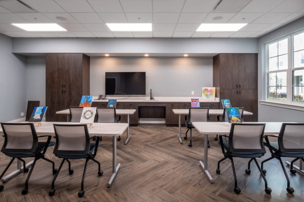 Bright activity room with tables and art displays