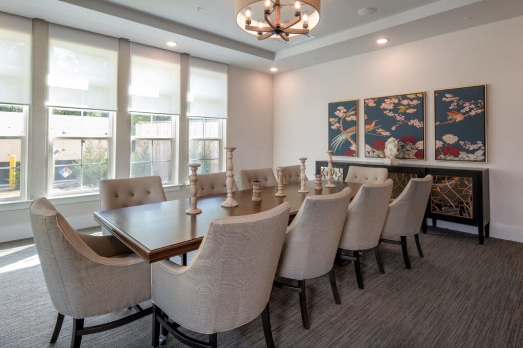 A bright dining room with a large table and elegant decor