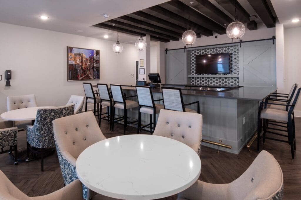 Bright common area with seating and a bar