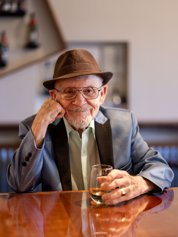 Elderly man enjoying a drink at a bar
