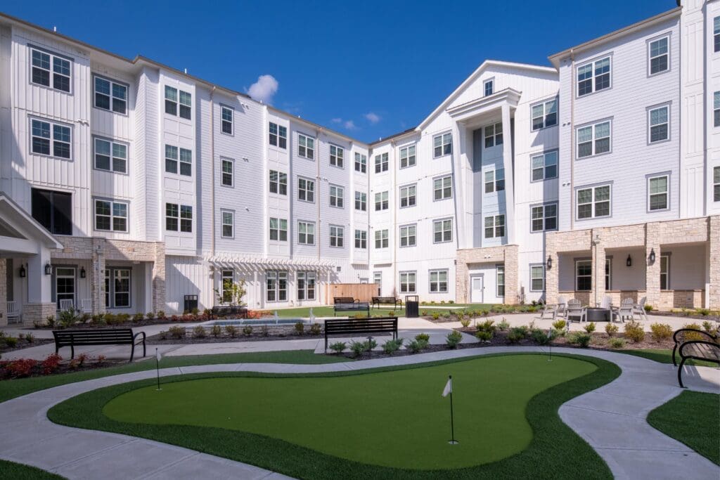 Outdoor courtyard with putting green and seating areas