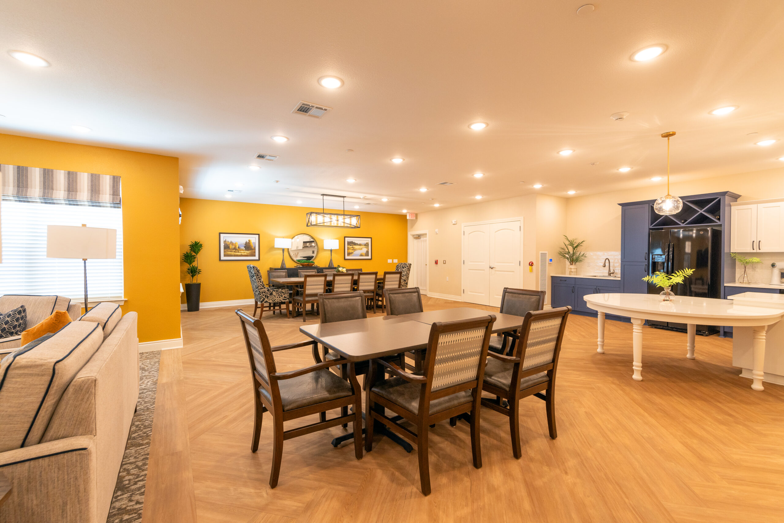 Interior view of a spacious common area with dining tables