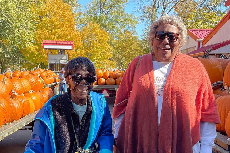 Two residents enjoying a pumpkin patch visit