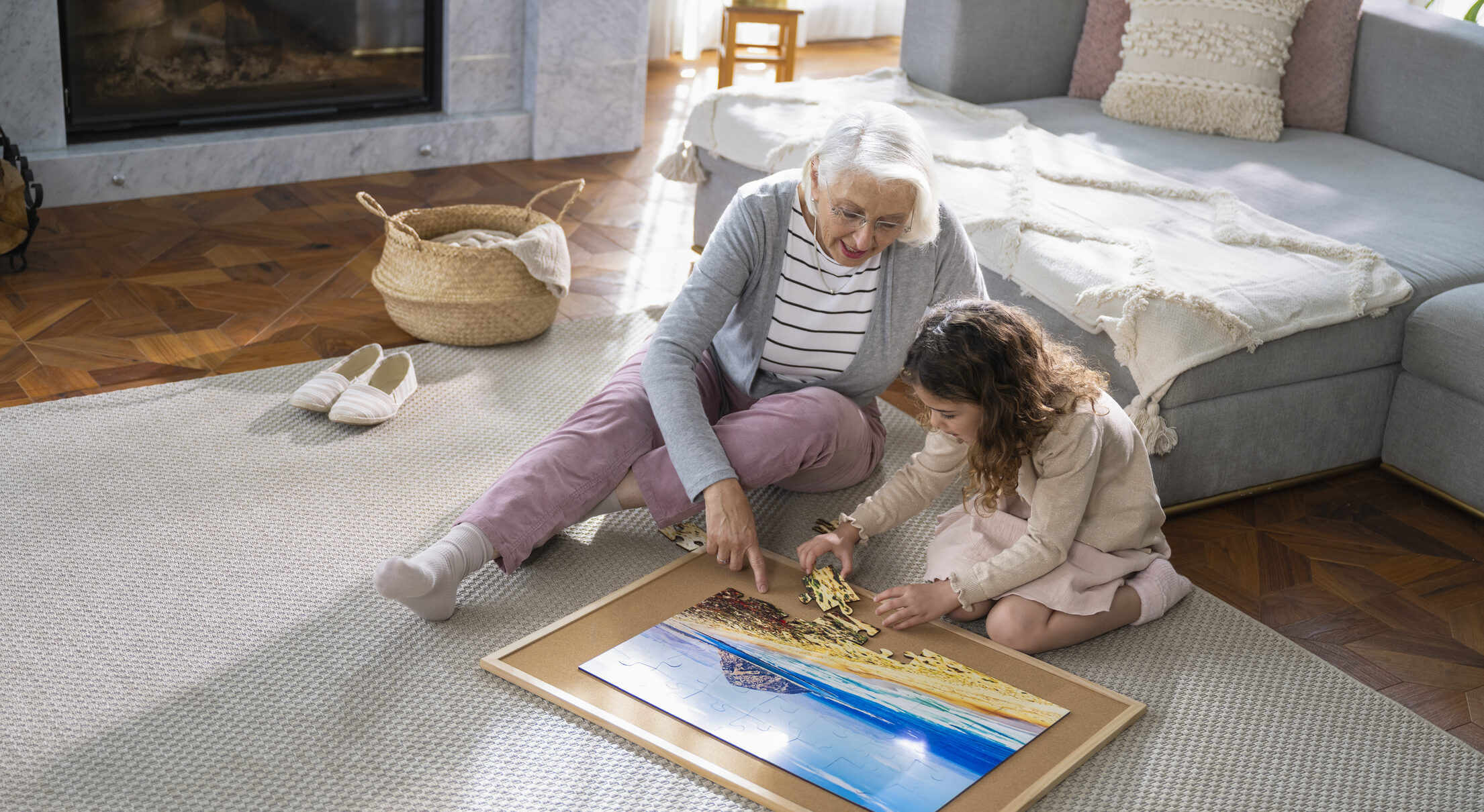 A resident and a child playing with a puzzle in a cozy living area