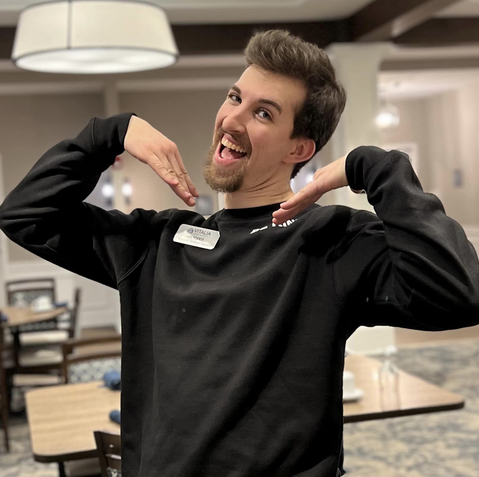 Staff member posing happily in the dining area