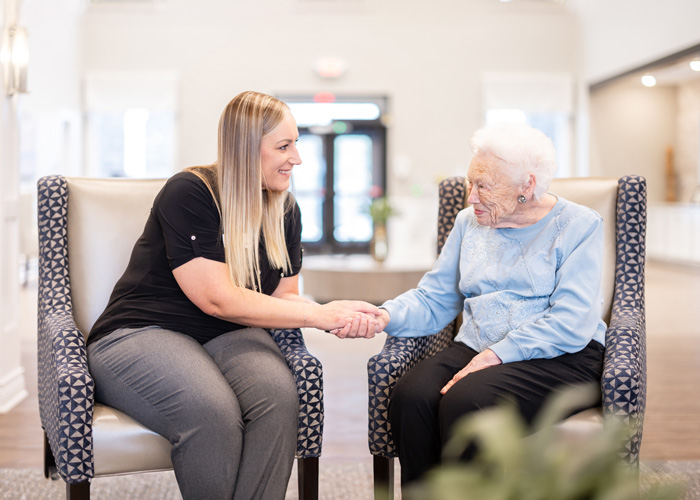 Caregiver and resident sharing a moment in a cozy interior
