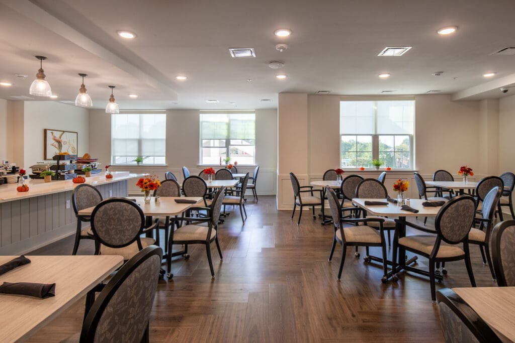 Interior view of a dining room with tables and flowers