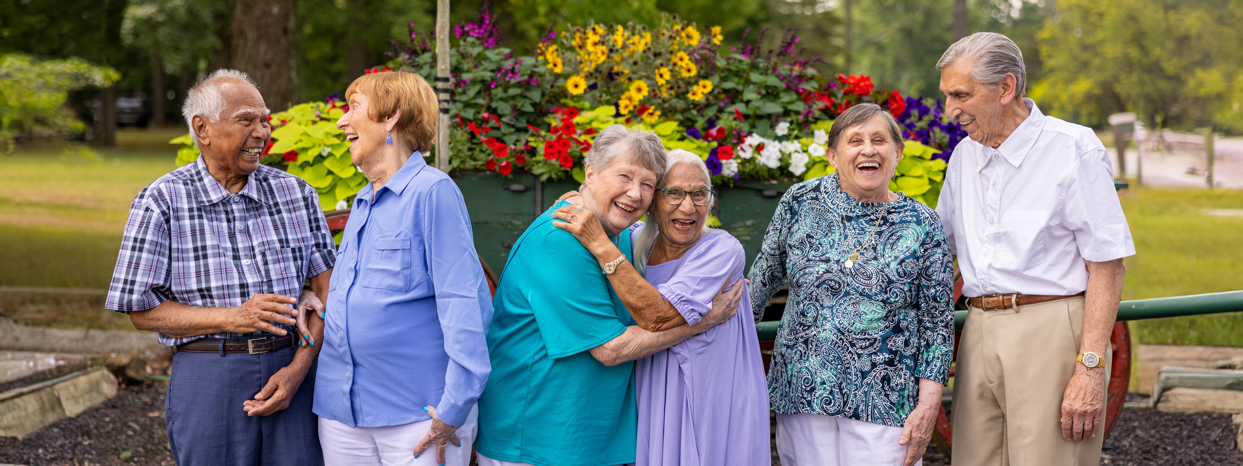 Residents enjoying a cheerful moment outdoors among flowers