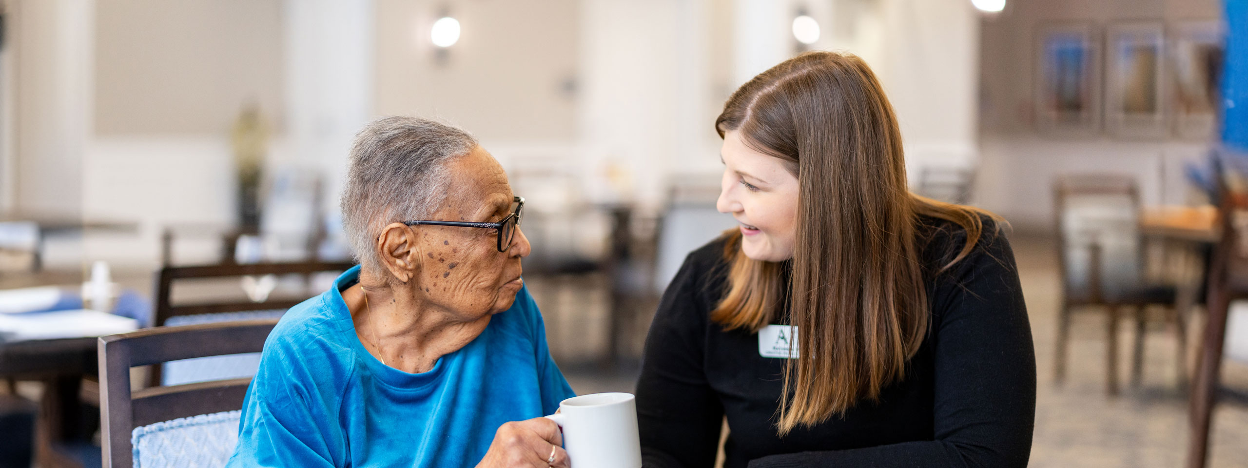 Staff member interacting with a resident in a common area