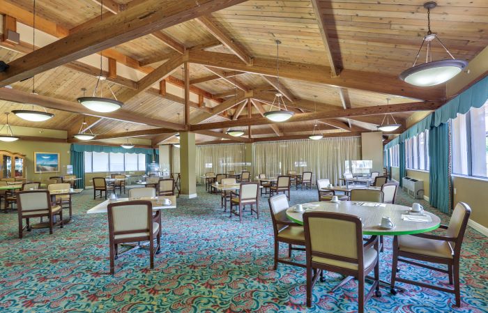 Bright dining room with wooden beams and tables