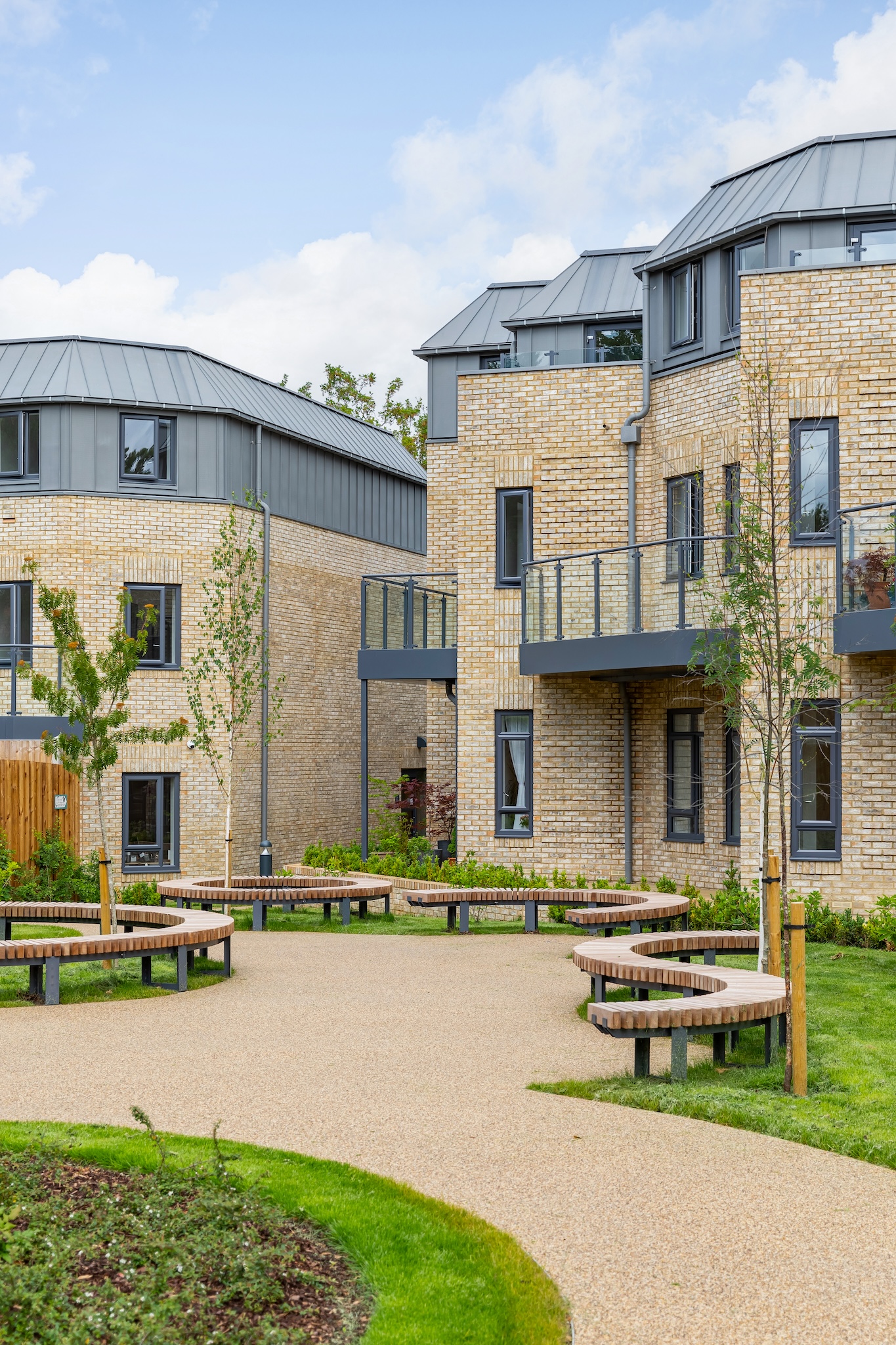 Outdoor area with circular benches and building facade
