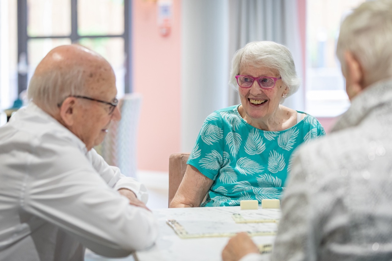 Seniors enjoying a conversation at a table