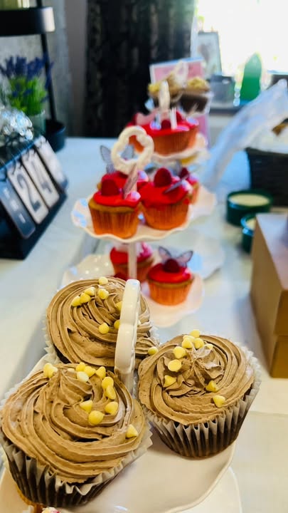 A display of decorated cupcakes on a tiered stand