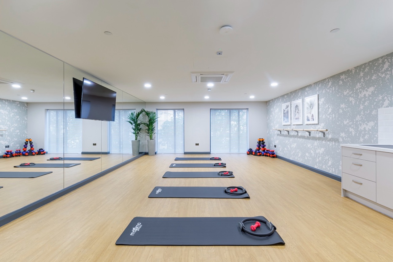 A fitness room with mats and exercise equipment