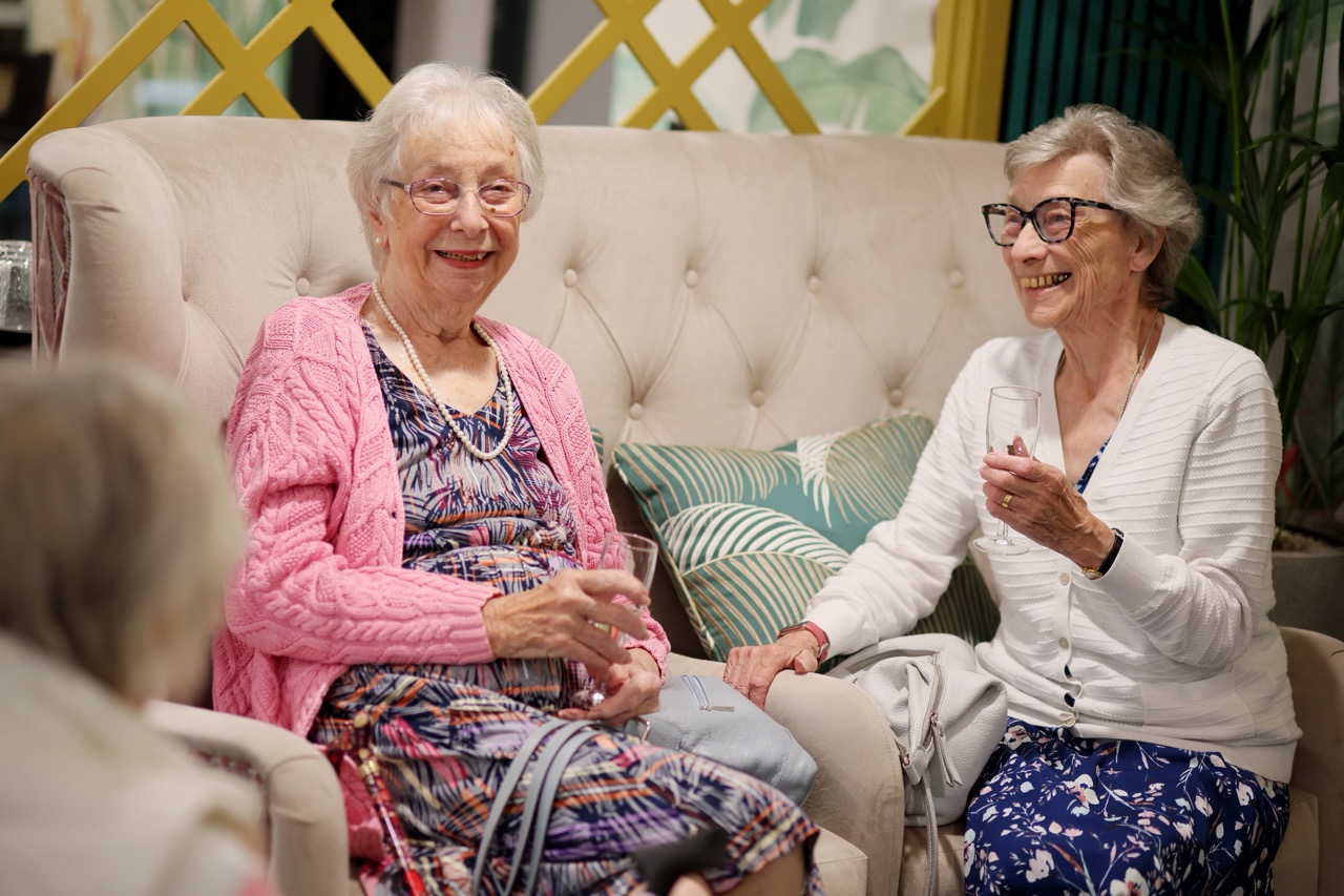 Residents enjoying conversation in a comfortable lounge