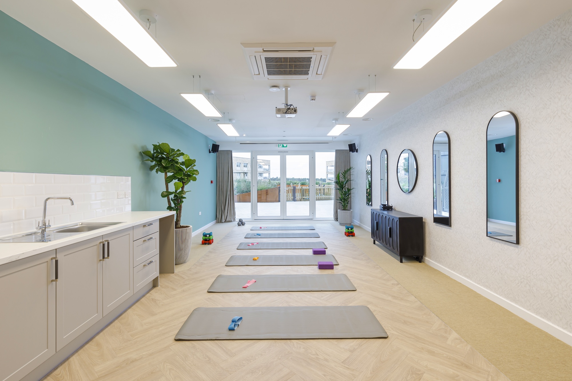 Bright interior fitness/activity room with exercise mats