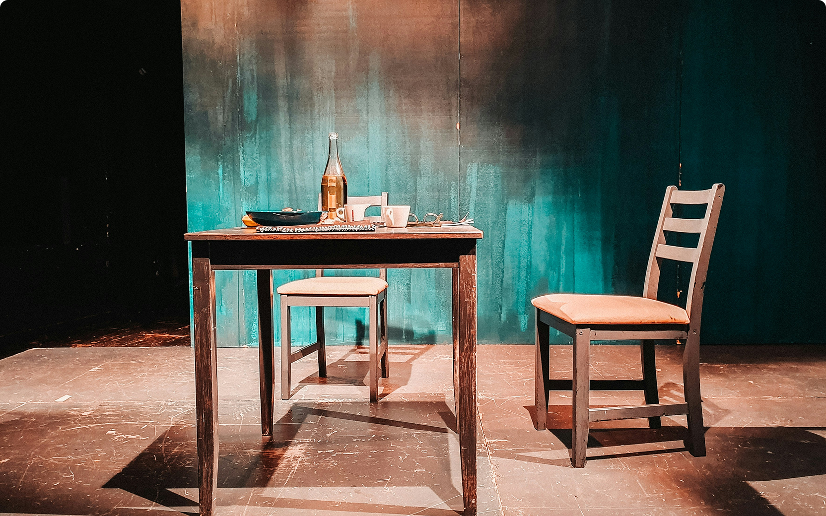 Empty dining table with two chairs on stage