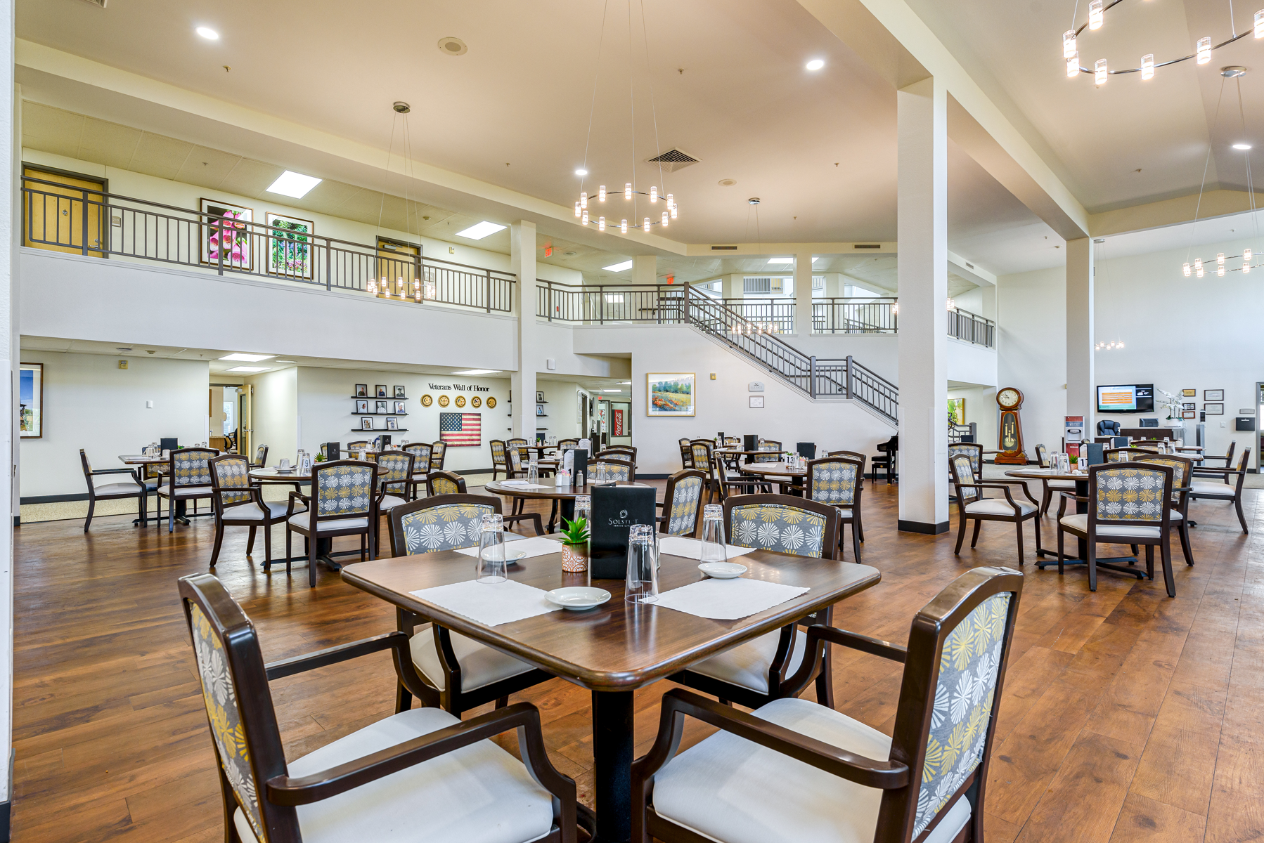 Dining room with tables and chairs set up for residents