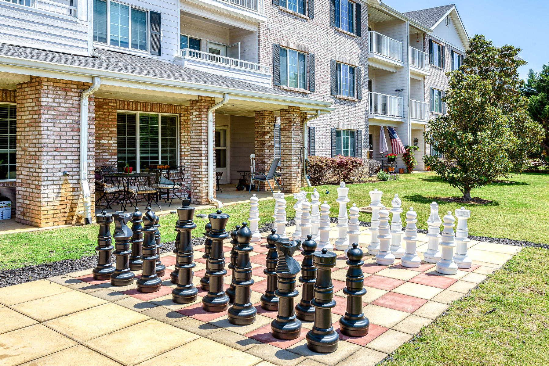Outdoor chess area with large pieces in front of the building