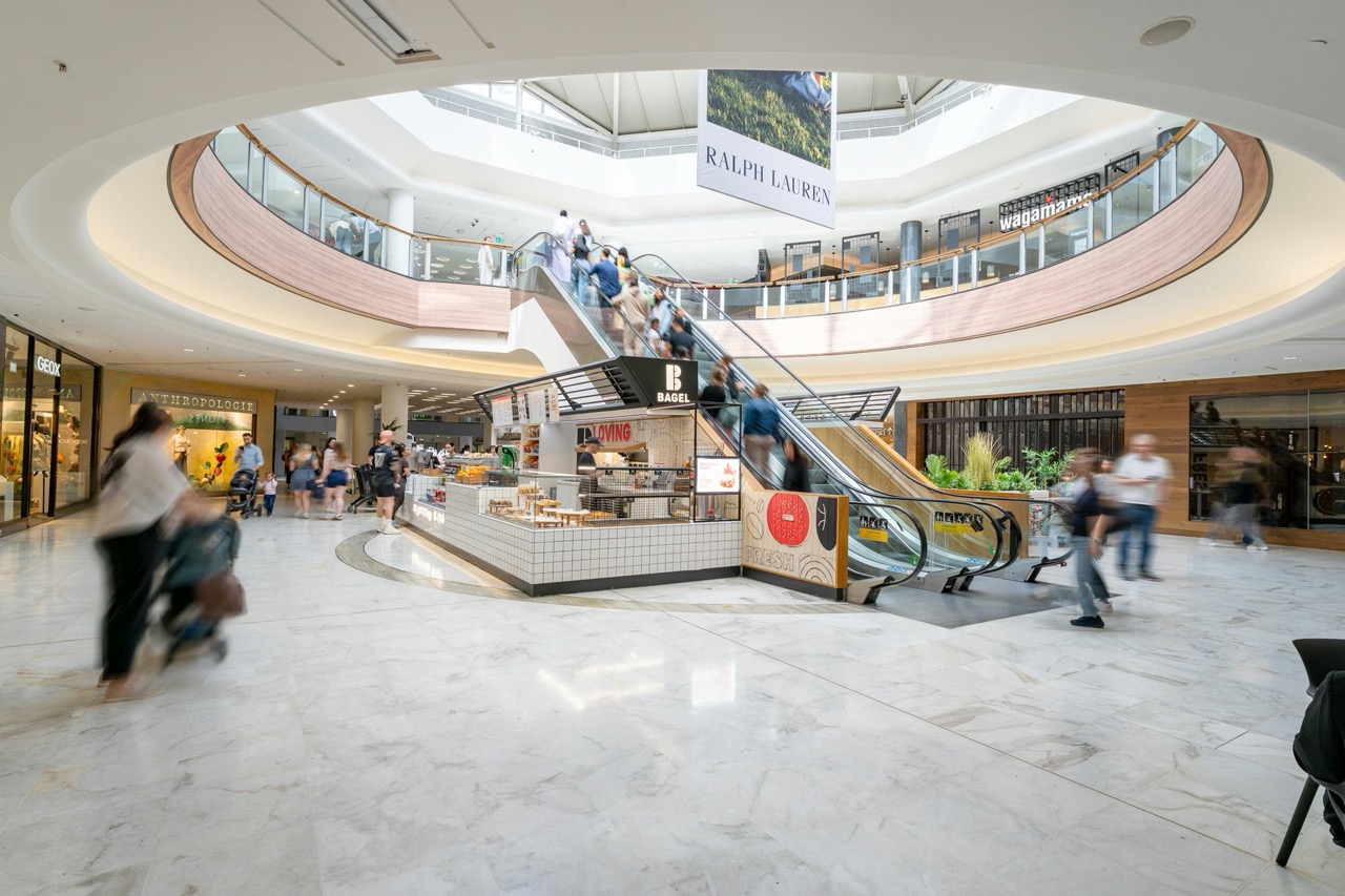 Busy shopping mall with people and escalators