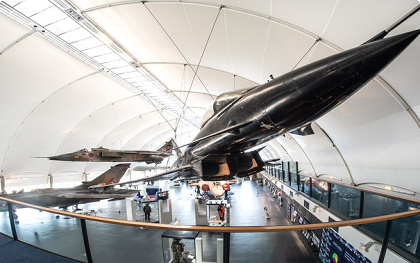 Interior view of a museum with aircraft displays